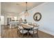 Dining room with a round table next to an open kitchen and white cabinets and countertops at 188 Brightwater Dr # 2, Clearwater Beach, FL 33767