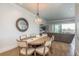Elegant dining room features a round table, pendant lighting, and views through sliding glass doors at 188 Brightwater Dr # 2, Clearwater Beach, FL 33767