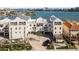Beautiful white three-story waterfront building featuring multiple balconies and a well-manicured private entrance at 188 Brightwater Dr # 2, Clearwater Beach, FL 33767