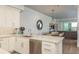 Kitchen area with an island and granite countertop, stainless steel appliances, and view to the dining room at 188 Brightwater Dr # 2, Clearwater Beach, FL 33767