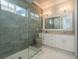 Luxurious bathroom featuring a glass-enclosed shower, dual sinks, a vanity, and modern fixtures at 188 Brightwater Dr # 2, Clearwater Beach, FL 33767