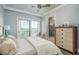 Light-filled main bedroom with balcony, water views, a ceiling fan, and ensuite bathroom at 188 Brightwater Dr # 2, Clearwater Beach, FL 33767