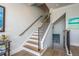 A staircase leading to the upper level, complemented by modern lighting at 188 Brightwater Dr # 2, Clearwater Beach, FL 33767