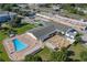 Aerial view of a recreation center, pool, and outdoor patio area with tables and umbrellas at 1950 59Th N Ave # 212, St Petersburg, FL 33714