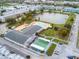 Aerial view of a community featuring a pool, shuffleboard courts, recreation center and a pond at 1950 59Th N Ave # 212, St Petersburg, FL 33714