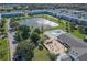 Aerial view featuring pool and pond surrounded by lush landscaping and community buildings at 1950 59Th N Ave # 212, St Petersburg, FL 33714