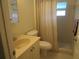Cozy bathroom features a shower with a neutral-toned curtain, and a light-colored vanity at 1950 59Th N Ave # 212, St Petersburg, FL 33714