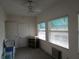 Light-filled bedroom with ceiling fan, two large windows, and carpeting at 1950 59Th N Ave # 212, St Petersburg, FL 33714