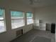 Sunlit bedroom with three windows, ceiling fan, and convenient built-in shelving at 1950 59Th N Ave # 212, St Petersburg, FL 33714
