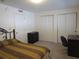 Bedroom with a patterned brown and tan bedspread, desk, closet, and dark dresser at 1950 59Th N Ave # 212, St Petersburg, FL 33714