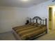 Bedroom with a patterned brown and tan bedspread, and simple decor at 1950 59Th N Ave # 212, St Petersburg, FL 33714