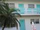 Condo exterior shows a two-story building with turquoise doors and a palm tree at 1950 59Th N Ave # 212, St Petersburg, FL 33714