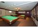 Well-lit game room featuring three billiard tables, ceiling fan, and cue stick storage at 1950 59Th N Ave # 212, St Petersburg, FL 33714