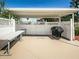 Outdoor grilling area features a built-in grill, picnic table, and white picket fencing at 1950 59Th N Ave # 212, St Petersburg, FL 33714