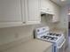 Bright kitchen features white cabinets, a gas range, and plenty of counter space at 1950 59Th N Ave # 212, St Petersburg, FL 33714