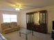 Living room with a sofa, mirrored cabinet, ceiling fan, and a large window for natural light at 1950 59Th N Ave # 212, St Petersburg, FL 33714
