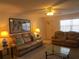 Living room with carpet, two sofas, and lamps offering soft, ambient lighting at 1950 59Th N Ave # 212, St Petersburg, FL 33714