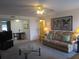 Living room showing a sofa, table, television, and view into an adjacent dining nook at 1950 59Th N Ave # 212, St Petersburg, FL 33714