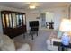 Carpeted living room with a ceiling fan, modern furniture, and a glimpse into the kitchen at 1950 59Th N Ave # 212, St Petersburg, FL 33714