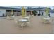 Outdoor seating area offers ample seating with table and chair sets and umbrellas for shade at 1950 59Th N Ave # 212, St Petersburg, FL 33714