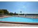 Community swimming pool featuring a clear blue pool, lounge chairs and a view of a lake at 1950 59Th N Ave # 212, St Petersburg, FL 33714
