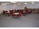 Community center reading room with multiple tables, chairs, and a large bookshelf with many books at 1950 59Th N Ave # 212, St Petersburg, FL 33714
