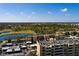 Aerial view of condo complex overlooking a picturesque pond, lush golf course and parking lot at 2617 Cove Cay Dr # 710, Clearwater, FL 33760