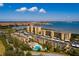 Beautiful aerial view of the condo buildings, pool, and surrounding waterfront on a sunny day at 2617 Cove Cay Dr # 710, Clearwater, FL 33760