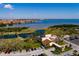 A beautiful aerial view showcases a pond, golf course and buildings, along the waterfront at 2617 Cove Cay Dr # 710, Clearwater, FL 33760