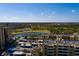 Scenic aerial of condo buildings and community overlooking lush golf course, water feature, and parking area at 2617 Cove Cay Dr # 710, Clearwater, FL 33760