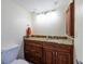 Bathroom featuring a granite countertop vanity, wooden cabinets, and a nearby toilet at 2617 Cove Cay Dr # 710, Clearwater, FL 33760