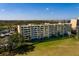 Scenic view of a condo community overlooking lush grounds, nearby lake, and manicured landscaping at 2617 Cove Cay Dr # 710, Clearwater, FL 33760
