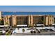 Multi-story waterfront condo with a parking area, palm trees, and views of the bay and bridge at 2617 Cove Cay Dr # 710, Clearwater, FL 33760