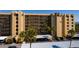 Close exterior view of the condo building, with covered parking, palm trees and landscaping at 2617 Cove Cay Dr # 710, Clearwater, FL 33760