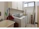 The laundry room includes a washer and dryer and extra cabinet space at 2617 Cove Cay Dr # 710, Clearwater, FL 33760