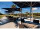 Outdoor tables and seating with umbrellas are adjacent to a golf course and pond at 2617 Cove Cay Dr # 710, Clearwater, FL 33760