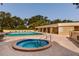 Community pool and hot tub with brick patio and various seating areas at 2617 Cove Cay Dr # 710, Clearwater, FL 33760