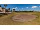 Golf course sand trap with rake and a green in the background at 2617 Cove Cay Dr # 710, Clearwater, FL 33760