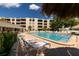 Community swimming pool and outdoor lounge area offer relaxing resort-style living at 2617 Cove Cay Dr # 710, Clearwater, FL 33760