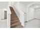 Staircase with wood treads, white risers, and white handrail ascends to the second floor at 2748 Garden Plum Pl, Odessa, FL 33556