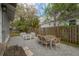 Backyard stone patio featuring outdoor dining and seating area and a view of the wooden fence at 311 W Chelsea St, Tampa, FL 33603