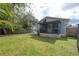 A spacious fenced backyard with a screened lanai and a well-maintained lawn area at 311 W Chelsea St, Tampa, FL 33603