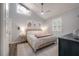 A modern bedroom with vaulted ceilings, a decorative ceiling fan, and natural light from a window at 311 W Chelsea St, Tampa, FL 33603
