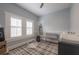 Light filled bedroom featuring two windows with white shutters, built-in shelves and a stylish rug at 311 W Chelsea St, Tampa, FL 33603