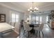 Open dining room showcasing a modern chandelier and seamless flow into the inviting kitchen and cozy living room at 311 W Chelsea St, Tampa, FL 33603