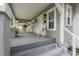 Cozy front porch with a swing, white wicker chair, and view of the home's exterior paint and shutters at 311 W Chelsea St, Tampa, FL 33603