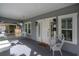 Relaxing front porch featuring a swing, wicker chair, and a clear view of the front door and exterior at 311 W Chelsea St, Tampa, FL 33603