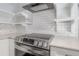 Kitchen details include stainless range with hood and open shelves against white subway tile at 311 W Chelsea St, Tampa, FL 33603