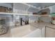 Kitchen features white cabinets, subway tile backsplash, open shelves, apron front sink, and modern faucet at 311 W Chelsea St, Tampa, FL 33603