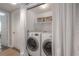 Laundry room with modern washer, dryer, and functional storage at 311 W Chelsea St, Tampa, FL 33603